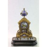 French Gilt key wind metal mantle clock with painted Enamel dial, panel and finial and a vintage