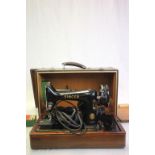 Cased Singer electric sewing machine and accessories, model 99k