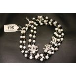 A long row of black and white freshwater pearls with designer spacers