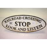 Cast iron railway type oval sign marked "Railroad Crossing Stop Look & Listen"