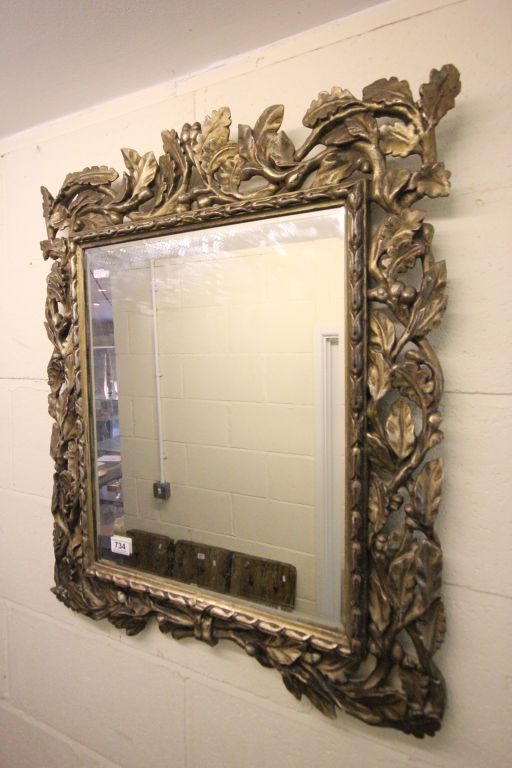 Ornately carved wood mirror with oak leaf decoration