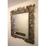 Ornately carved wood mirror with oak leaf decoration