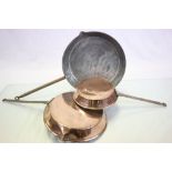 A set of three graduating antique copper frying pans