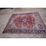 Large Eastern Wool Rug, red and blue ground with geometric patterns