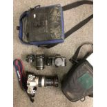 Two Canon SLR cameras with cases and lenses
