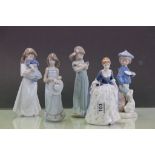 A Lladro figure of a girl with two kittens and another Lladro figure of a girl clutching a hat,