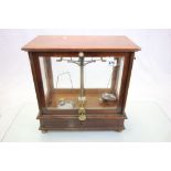 Mahogany cased set of Chemist scientific balance scales with glazed panels and box of weights