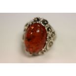 A large silver and amber style dress ring