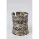 A silver cuff bracelet marked 925, floral and foliate scroll decoration with rope twist bands and