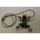 An unusual silver marcasite and onyx frog pendant necklace on silver chain