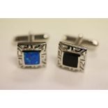 A pair of silver Harlequin style cufflinks