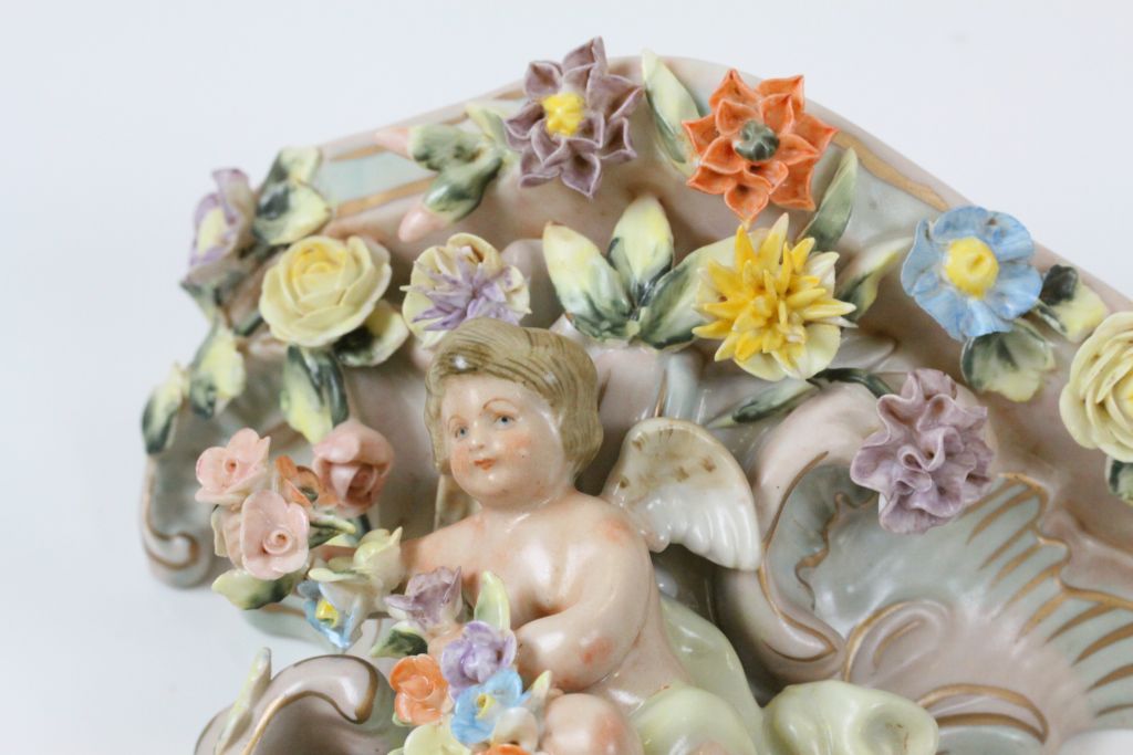 A pair of Continental hand painted cherub wall pockets, the cherub laying amongst roses, dahlias and - Image 4 of 8