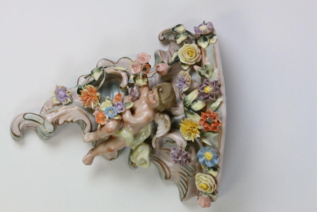 A pair of Continental hand painted cherub wall pockets, the cherub laying amongst roses, dahlias and - Image 2 of 8