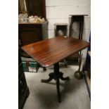 A 19th century mahogany tiltop top tripod table with turned column raised on swept pad feet.