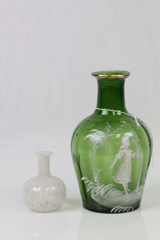 A Victorian Mary Gregory green glass vase with white enamelled garden scene of girl with bird,