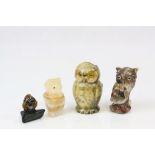 A carved soapstone owl figurine, a carved banded agate owl figurine together with two other owl