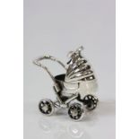 An unusual silver model of a perambulator