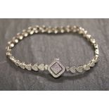A silver and CZ bracelet with heart shaped clasp
