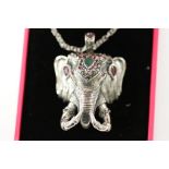 An unusual silver elephant head pendant necklace set emerald and rubies on silver chain