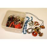 A collection of vintage costume jewellery to include clarified amber jewellery, Chinese silver charm