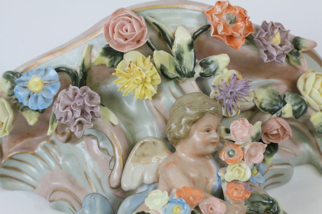 A pair of Continental hand painted cherub wall pockets, the cherub laying amongst roses, dahlias and - Image 5 of 8