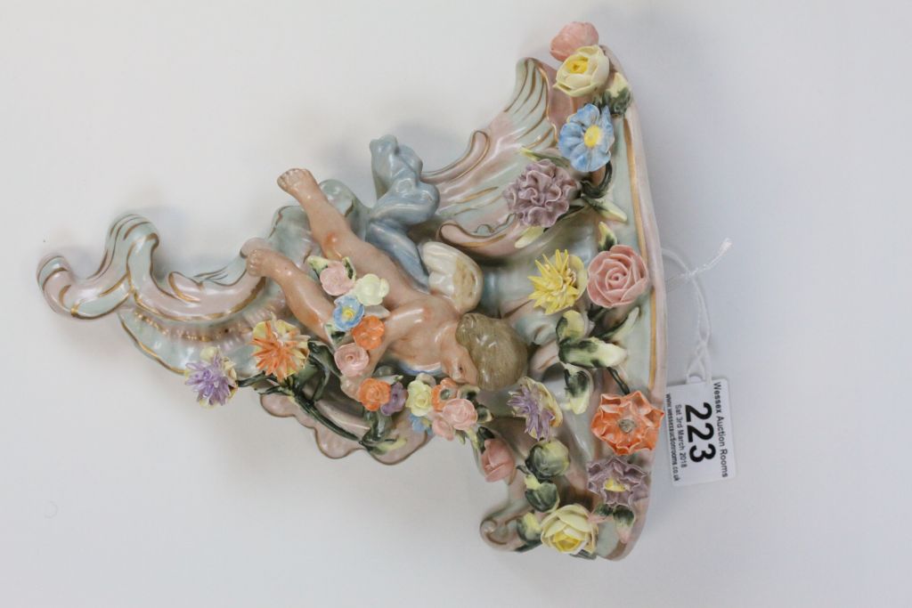 A pair of Continental hand painted cherub wall pockets, the cherub laying amongst roses, dahlias and - Image 3 of 8