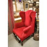 Early 20th century Wingback Armchair on Mahogany Legs, Upholstered in Crimson Velvet and stamped W.