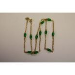 An 18ct yellow gold necklace inset with green bead spacers