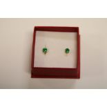 A yellow gold pair of emerald stud earrings