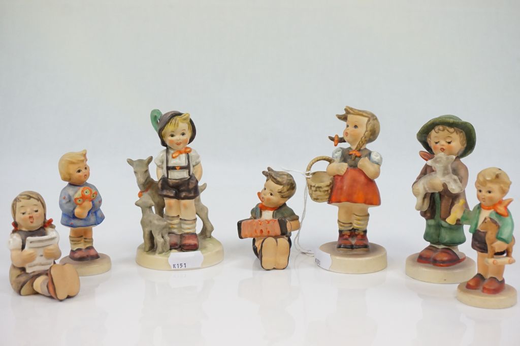 Seven Goebel Hummel figurines and a Collectors Guide