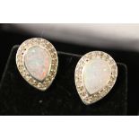 A pair of silver and opal pear shaped stud earrings