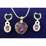 An amethyst heart shaped silver pendant necklace, the rub over set cabochon cut heart shaped