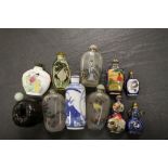 Oriental snuff bottles to include reverse painted glass, ceramic and cloissone examples, together