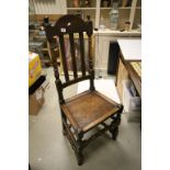An 18th century oak side chair with turned supports.