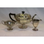 A George V silver three piece tea service, comprising teapot, milk jug and sugar bowl, octagonal