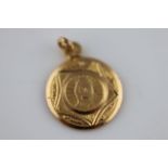 A yellow metal St Christopher pendant, approximately 18mm, tests as a minimum of 18ct gold, Egyptian