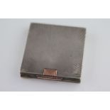 An Art Deco silver compact, square form with sunburst design, gilt geometric clasp detail, London