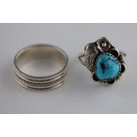 A turquoise silver Navajo style ring, the tumbled turquoise stone set to centre with flower, leaf