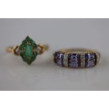 An emerald and diamond unmarked yellow gold marquise cluster ring, the marquise mixed cut centre