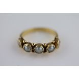 A Victorian pearl unmarked yellow gold ring, five rub over set pearls, the centre pearl measuring