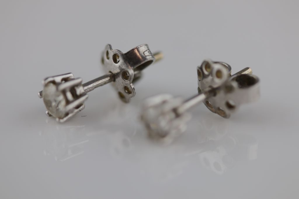 A pair of diamond solitaire white metal stud earrings, each round brilliant cut diamond weighing - Image 2 of 3