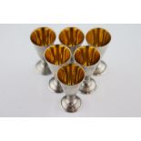 A set of six silver Russian tot glasses (875 fineness), gilt interior to tapered bowls, inverse