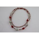 A circa 1920s glass bead necklace attributed to the Neiger Brothers, comprising carved opaque red