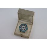 An early 20th century enamelled silver octagonal pill box, blue and cream guilloche enamel with pink