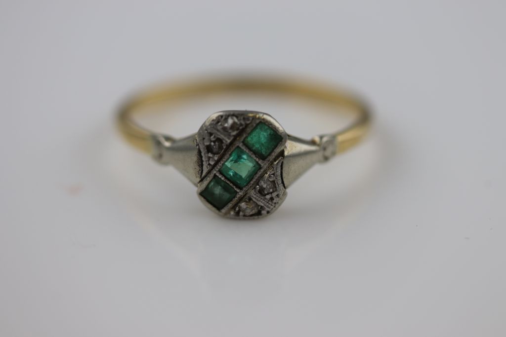 An Art Deco emerald and diamond 18ct yellow gold platinum set ring, the rounded rectangular head