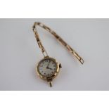 A ladies 9ct gold cased wristwatch, the engine turned silvered enamel dial signed Thomas Russell &