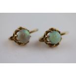 A pair of precious white opal unmarked yellow gold drop earrings, the round cabochon cut opals