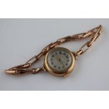 A 1930s 9ct gold cased wristwatch on 9ct rose gold expanding strap, champagne dial with black Arabic