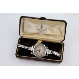 A ladies silver wristwatch, circa 1930s, blue Arabic numerals, black elongated poker hands, engraved