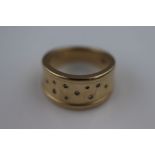 A diamond unmarked gold ring assessed as 9ct gold with 10 small eight cut diamonds, band width